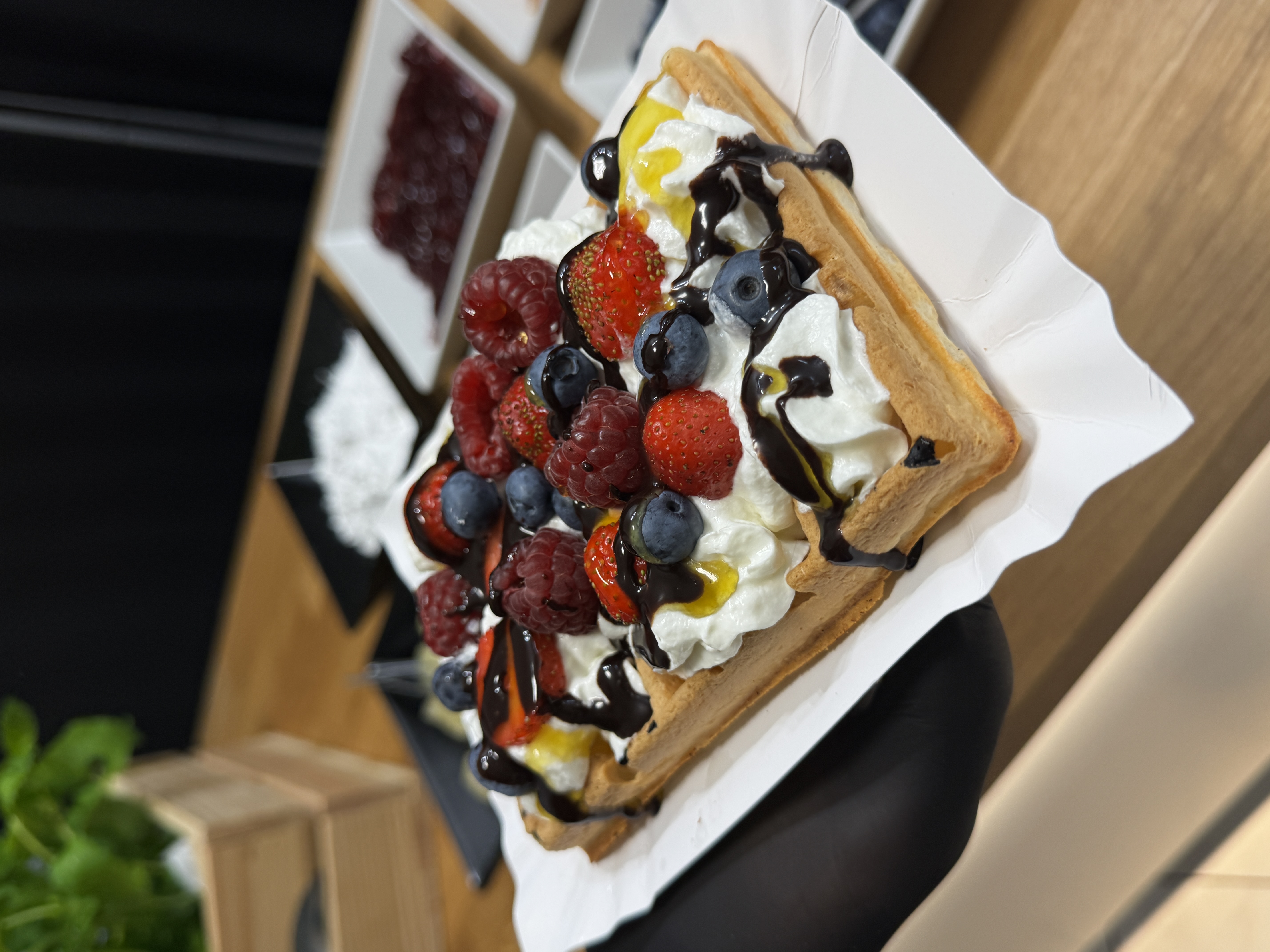 Waffles with fruit and whipped cream at a mobile stand